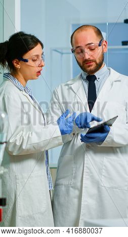 Chemist Nurse Explainig To Doctor Vaccine Development
