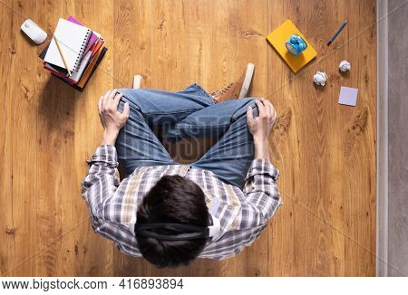 Man relaxing on floor thinking idea solitions. Man student studying online lesson siiting on floor. Creative inspiration study concept