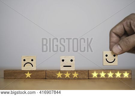 Hand Putting Smiley Face And Golden Yellow Stars Which Print Screen On Wooden Cube Block For Custome