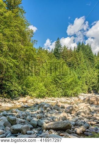 Dried Stoney Waterway Of Montailn River On Bright Summer Day