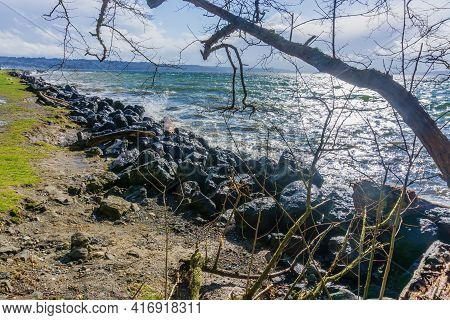 Back Rocks Lin The Shore On A Windy Day At Satlwater State Park In Washington State.