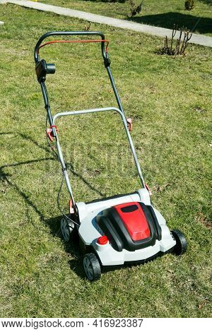 Aerator Standing In Grass. Aeration With A Scarifier. Using A Scarifier In The Garden To Improving Q