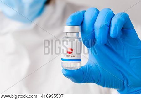 Sinovac Vial Or Bottle For Injection With Pharmaceuticals Or Drugs In Scientist Hands In Rubber Glov