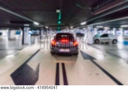 Garage Car Blurred. Car Lot Parking Space In Underground City Garage. Empty Road Asphalt Background 