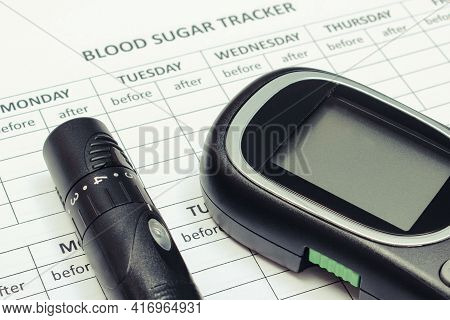 Glucose Meter And Lancet Device On Empty Medical Forms For Measurement Sugar In Blood. Checking Suga