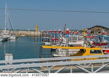 Pyeongtaek, South Korea; April 6, 2021:row Of Yachts And Tour Boats Docked At Jeongok Marina With Ye