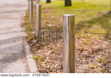 Pole Barriers On Footpath For Blocking Vehicles Not Drive On The Sidewalk In The Park. Bollard. Pers