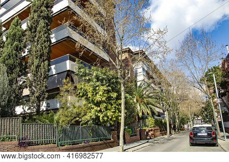 Spain, Barcelona, March, 2021: Modern Multi-storey Architecture With Good Urban Greening In Quiet Of