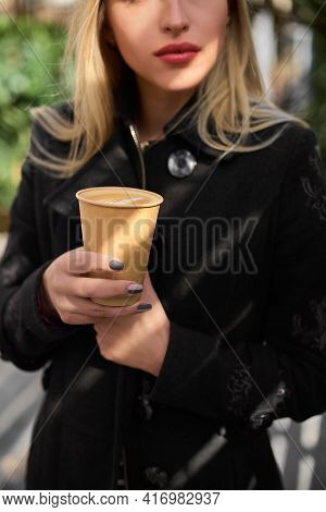 Cup With Coffee In Girls Hands Morning Background. Paper Cup With Cappuccino And The Girls Hand