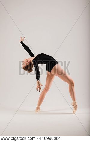 Portarit Of Sensual Professional Caucasian Callet Dancer In Body Suit And Pointes Shoes On White.