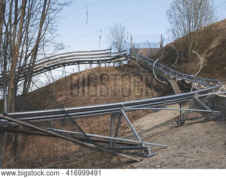 Inactive Sports Equipment. Toboggan And Ski Lifts In Spring. Concept Of Standing Idle And Standby