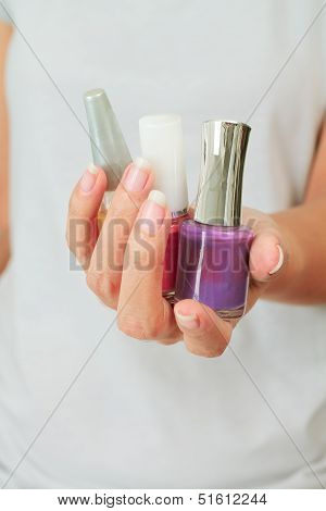 Female Hand With Nail Varnish Bottles