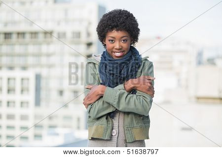 Shivering casual woman posing outdoors on a sunny day