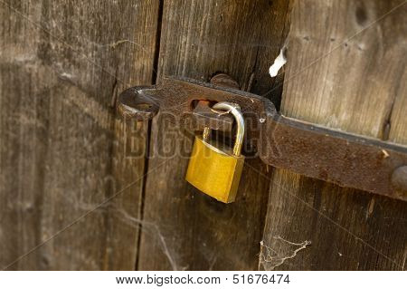 Padlock on an old wooden barn door