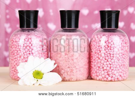 Aromatherapy minerals - colorful bath salt on pink background
