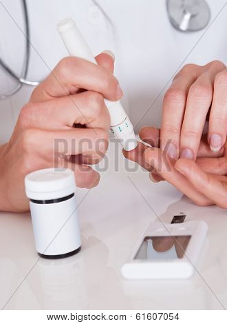 Doctor Testing A Patients Glucose Level