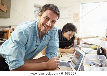Two Architects Making Models In Office Using Digital Tablet