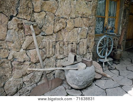 Ancient Tools And Everyday Objects Next To The Wall
