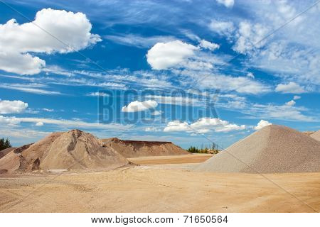 Sand heaps with blue sky