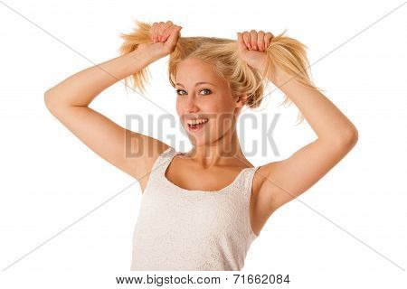 Beautiful Young Blonde Woman Holds Hair In Her Hand Gesturing Excitement Isolated Over White Backgro