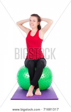 Young woman exercising with swiss ball