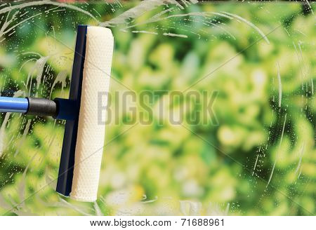 Cleaning windows with special squeegee