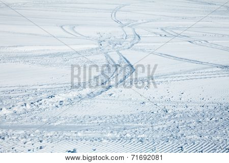 Ski tracks on a fresh groomed piste