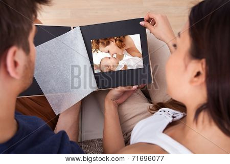 Couple Looking Through Photo Album