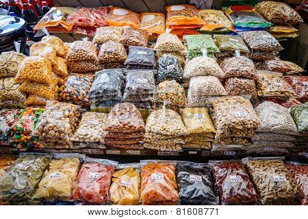 Dried fruits and nuts for sale at Gwangjang Market in Seoul, South Korea. (Visible Korean text is food name and price. All copyrighted logos and text removed)