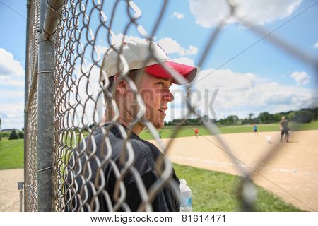 Teen boy on sidelines at baseball practice
