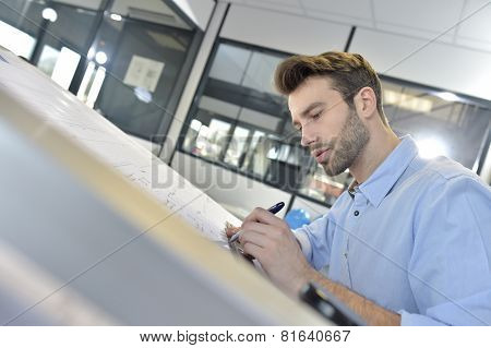 Architect designing on drafting table