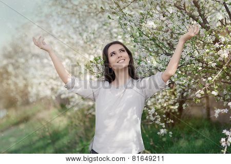 Happy Beautiful Girl in Spring Flowers Landscape