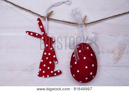 Red Easter Bunny And Easter Egg Hanging On Line