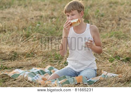 Teenage Farmer Boy Eating Fresh White Bread