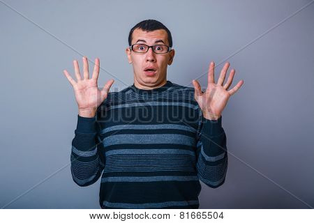 European-looking male of about thirty raised his hands palms out