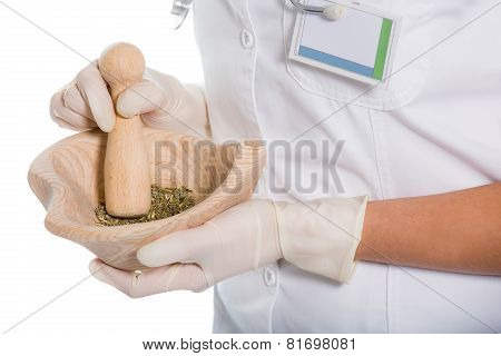 Woman doctor using a mortar and pestle, herbal medicine