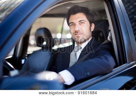 Portrait of an handsome guy driving his car