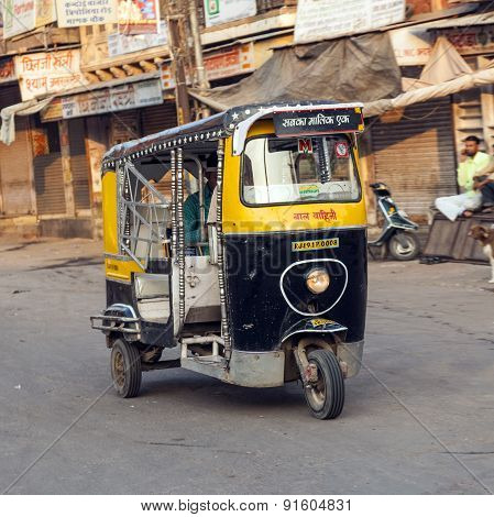 Auto Rickshaw Taxi Driver With Passengers In Operation