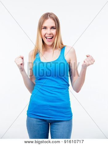 Pretty casual woman celebrating a triump isolated on a white background. Looking at camera. Wearing in jeans and blue t-shirt