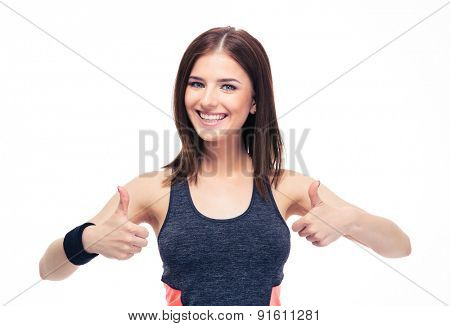 Smiling fitness woman showing thumbs up isolated on a white background. Looking at camera