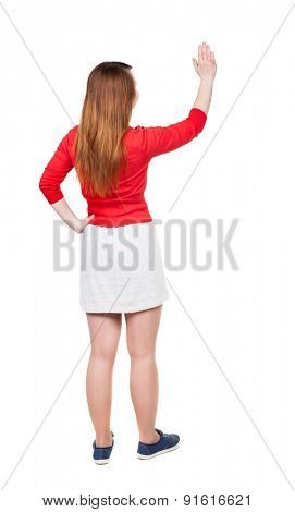 back view of standing young beautiful  woman. girl  watching. Rear view people collection. backside view person. Isolated over white background. Adding putting hands on waist stands and looks to right