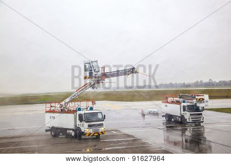 Deicing Truck Deices A Plane Before Take Off