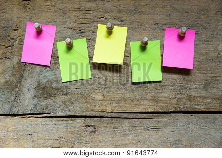 Five Blank Sticky Notes On Wooden Wall
