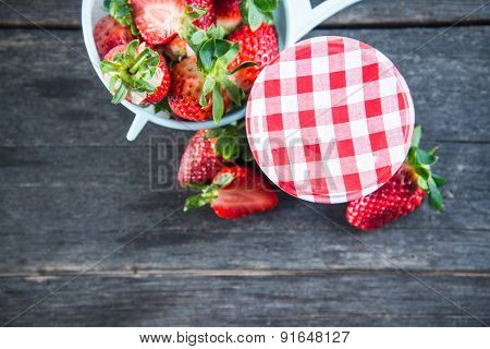Strawberry Jam With Whole Fruits On Wooden Table