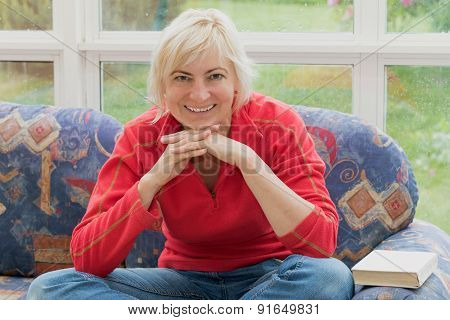 Blonde Middle-aged Woman Is Smiling To The Camera