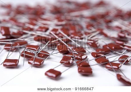 Electronic Components. Capacitors Placed Bulk On White Surface
