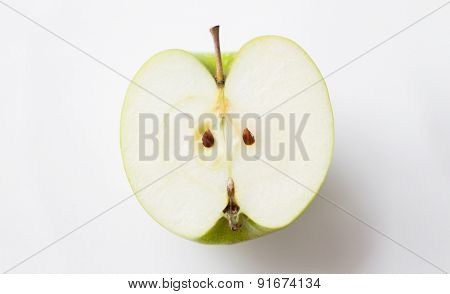 fruits, diet, eco food and objects concept - ripe green apple half over white