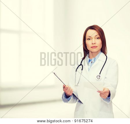 healthcare and medicine concept - calm female doctor with clipboard and stethoscope