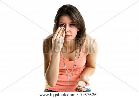 Beautiful young woman putting on make-up