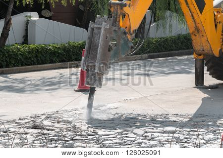 Excavator Breaking And Drilling The Concrete Road For Repairing